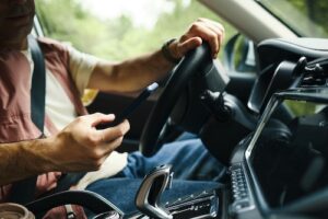 Man Looking At Phone While Driving - Distracted Driving