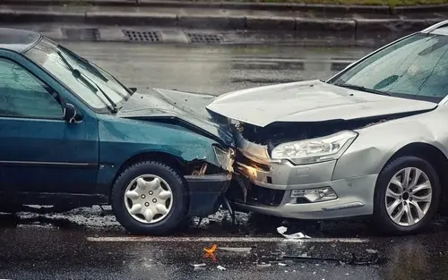 Two cars colliding in a mid-day crash representing the severe impact and consequences of Drunk Driving Accidents.