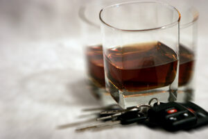 Alcoholic drink with car keys beside it symbolizing the dangers of Drunk Driving Accidents - Get represented by Knoxville Car Accident Lawyer.