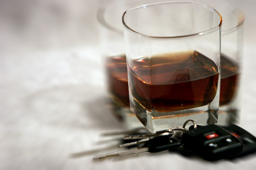 Alcoholic drink with car keys beside it symbolizing the dangers of Drunk Driving Accidents - Get represented by Knoxville Car Accident Lawyer.