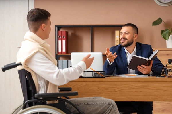 An Uber accident lawyer is meeting with a client at Knoxville Car Accident Lawyer.