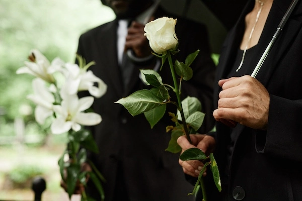 Two people at a funeral represent a wrongful death lawyer.